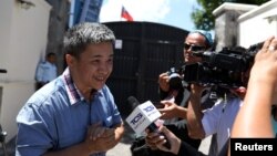 A Taiwanese citizen identified only as "William" speaks with the media outside the Taiwan embassy, Aug. 21, 2018.