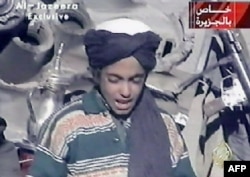 FILE - Hamza bin Laden, son of al-Qaida founder Osama bin Laden, is shown in this frame grab taken from the Al Jazeera news channel, Nov. 7, 2001. Hamza bin Laden has been trying to ease tensions with Islamic State in an effort to encourage the merger of IS fighters into al-Qaida.