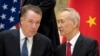 FILE - Chinese Vice Premier Liu He, right, talks with U.S. Trade Representative Robert Lighthizer, while they line up for a group photo in Beijing, Feb. 15, 2019.. 