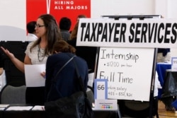 Illinois Department of Revenue employment recruiters speak to students looking for a full time jobs or an internship during The Foot in the Door Career Fair at the University of Illinois Springfield, Sept. 25, 2014.