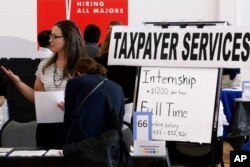 Illinois Department of Revenue employment recruiters speak to students looking for a full time jobs or an internship during The Foot in the Door Career Fair at the University of Illinois Springfield, Sept. 25, 2014.