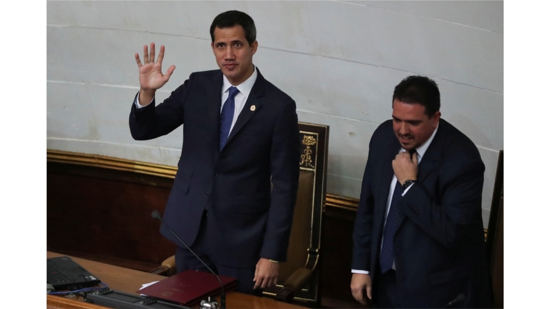 Venezuelan opposition leader Juan Guaido waves next to Stalin Gonzalez, second Vice President of the National Assembly, as they attend a session of the National Assembly in Caracas, Sept. 24, 2019.