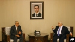 Progress in rebel efforts to create alternative government has been stalled by some in Syrian National Coalition who believe another route to peace may be achieved by UN-Arab League special envoy to Syria Lakhdar Brahimi, shown here with Syria’s foreign minister, Walid Mouallem. on September 13, 2012. (AP)
