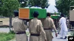 Pakistani troops carrying coffins of their colleagues allegedly killed in cross-border helicopter strike by NATO in Parachinar, Kurram, along Afghanistan's border, 30 Sep 2010