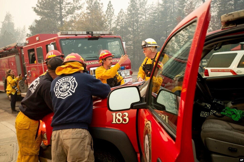 Firefighters plan their operations while battling the Camp Fire in Paradise, Calif., Nov. 10, 2018. 