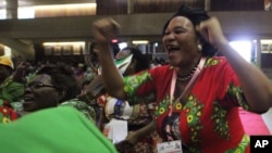 FILE: A woman reacts after Emmerson Mnangagwa was announced as one of the two vice Presidents at the Zanu pf headquarters in Harare,Wednesday, Dec, 10, 2014. (AP Photo/Tsvangirayi Mukwazhi)