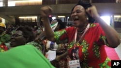 FILE: A woman reacts after Emmerson Mnangagwa was announced as one of the two vice Presidents at the Zanu PF headquarters in Harare,Wednesday, Dec, 10, 2014