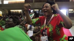FILE: A woman reacts after Emmerson Mnangagwa was announced as one of the two vice Presidents at the Zanu pf headquarters in Harare,Wednesday, Dec, 10, 2014. (AP Photo/Tsvangirayi Mukwazhi)