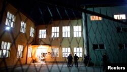 Kosovo police (KPS) secure the area in front of the ''Sveti Sava'' elementary school polling station in the northern part of the ethnically divided Kosovo town of Mitrovica, Nov. 3, 2013. 