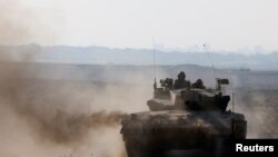 FILE—Israeli tank maneuvers near Israel's border with Gaza, amid the ongoing conflict between Israel and the Palestinian Islamist group Hamas, in southern Israel, April 7, 2024. 