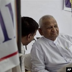 Indian social activist Anna Hazare, right, looks on during his hunger strike against corruption, in New Delhi, India, April 7, 2011