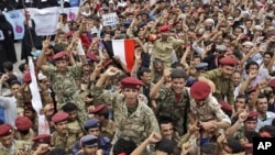 Yemeni army soldiers who defected are lifted by anti-government protestors during a demonstration demanding the resignation of President Ali Abdullah Saleh, in Sanaa, Yemen, June 15, 2011