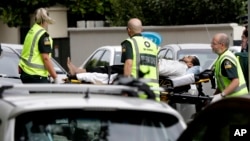 Ambulance staff take a man from outside a mosque in central Christchurch, New Zealand, Friday, March 15, 2019.