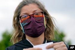 Alejandra poses with her vaccination card after getting her second Moderna COVID-19 shot Monday April 19, 2021, in Pasadena, Texas.