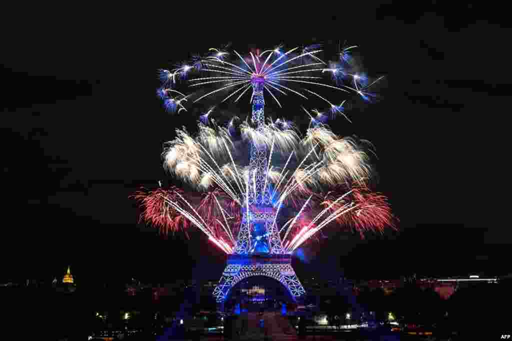 Fireworks explode above the Eiffel Tower as part of the annual Bastille Day celebrations in Paris, France, July 14, 2020.