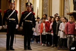 Schoolchildren look at soldiers moments before the arrival of U.S. Vice President Mike Pence at the Buenos Aires Metropolitan Cathedral in Argentina, Aug. 15, 2017. Pence participated in a wreath-laying ceremony to commemorate Jose de San Martin, an Argentine general who helped lead the revolution against Spanish rule in Argentina, Chile and Peru.