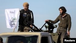 FILE - Turkish-backed Syrian rebels stand on the back of a truck at Manbij countryside, Syria, Dec. 29, 2018.