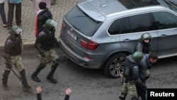 A demonstrator is taken away by Belarusian law enforcement officers during a rally to reject the presidential election results in Minsk, Belarus, Nov. 15, 2020. 