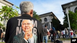 A supporter of former Prime Minister Najib Razak waits outside the Court of Appeals, in Putrajaya, Malaysia, Jan. 6, 2025, before Najib won an appeal to pursue his bid to serve his remaining corruption sentence under house arrest later Monday. 