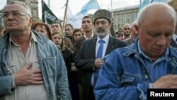 File - Crimean Tatars attend a rally marking the 71st anniversary of their mass deportation from the peninsula to distant parts of the Soviet Union, in Kyiv, Ukraine, May 2015.