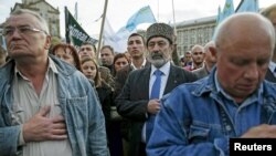 FILE - Crimean Tatars attend a rally marking the 71st anniversary of their mass deportation from the peninsula to distant parts of the Soviet Union, in Kyiv, Ukraine, May 2015.