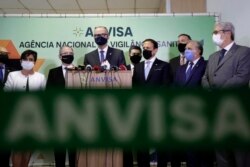 The Director of Brazil's National Health Surveillance Agency Antonio Barra speaks at a press conference regarding the CoronaVac vaccine, flanked by Sao Paulo Gov. Joao Doria, right center, in Brasilia, Brazil, Wednesday, Oct. 21, 2020. (AP Photo)