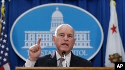 Gov. Jerry Brown discusses a lawsuit filed by 17 states and the District of Columbia over the Trump administration's plans to scrap vehicle emission standards during a news conference, May 1, 2018, in Sacramento, Calif.