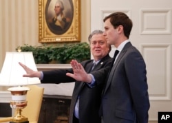 Steve Bannon, left, talks with White House senior adviser Jared Kushner in the Oval Office of the White House, Feb. 3, 2017.