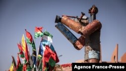 A statue of a cameraman stands at the Pan-African Film and Television Festival (FESPACO) headquarters in Ouagadougou, on Oct. 14, 2021.