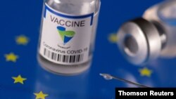 FILE - Vials labelled ‘Sinopharm coronavirus disease (COVID-19) vaccine’ displayed on an EU flag are seen in an illustration picture. Sinopharm is the first non-Western vaccine to be approved by the WHO.