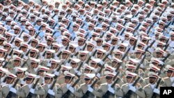 Iranian armed forces members march in a military parade, Sept. 21, 2016, marking the 36th anniversary of Iraq's 1980 invasion of Iran, in front of the shrine of late revolutionary founder Ayatollah Khomeini, just outside Tehran. 