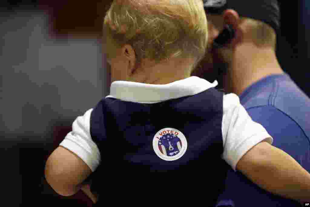 Ethan Deshotel, 19 months, sports an "I voted" sticker after his father A.J. Deshotel voted on Election Day at St. Dominic's School in the Lakeview section of New Orleans, Nov. 8, 2016.