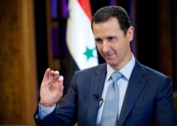 FILE - Syrian President Bashar al-Assad gestures during an interview in Damascus, February 10, 2015.