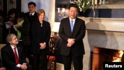 FILE - China's Vice President Xi Jinping (R) talks with area residents in the home of Roger and Sarah Lande in Muscatine, Iowa, Feb. 15, 2012. 