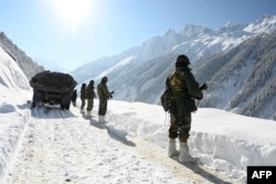 FILE - Indian soldiers locomotion  on  a roadworthy  adjacent   the Zojila upland  walk  that connects Srinagar to the territory   of Ladakh, bordering China, connected  Feb. 28, 2021.