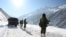 FILE - Indian army soldiers walk along a road near Zojila mountain pass that connects Srinagar to the union territory of Ladakh, bordering China on February 28, 2021.