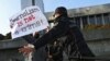 Police officers restrain a protester during a rally of journalists against a new media bill, in front of the Parliament building in Baku, Azerbaijan, on Dec. 28, 2021. 