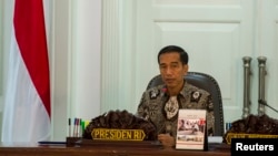 FILE - Indonesia's President Joko Widodo leads a cabinet meeting at the Presidential Palace in Jakarta, March 4, 2015.