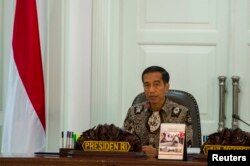 FILE - Indonesia's President Joko Widodo leads a cabinet meeting at the Presidential Palace in Jakarta, March 4, 2015.