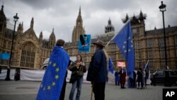 Anti-Brexit and remain in the European Union supporters stand near Houses of Parliament in London, April 3, 2019. After failing to win Parliament's backing for her Brexit blueprint, Britain's Prime Minister Theresa May changed gears, saying she would seek a compromise.