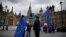 FILE - Anti-Brexit and remain in the European Union supporters stand near Houses of Parliament in London, April 3, 2019. 