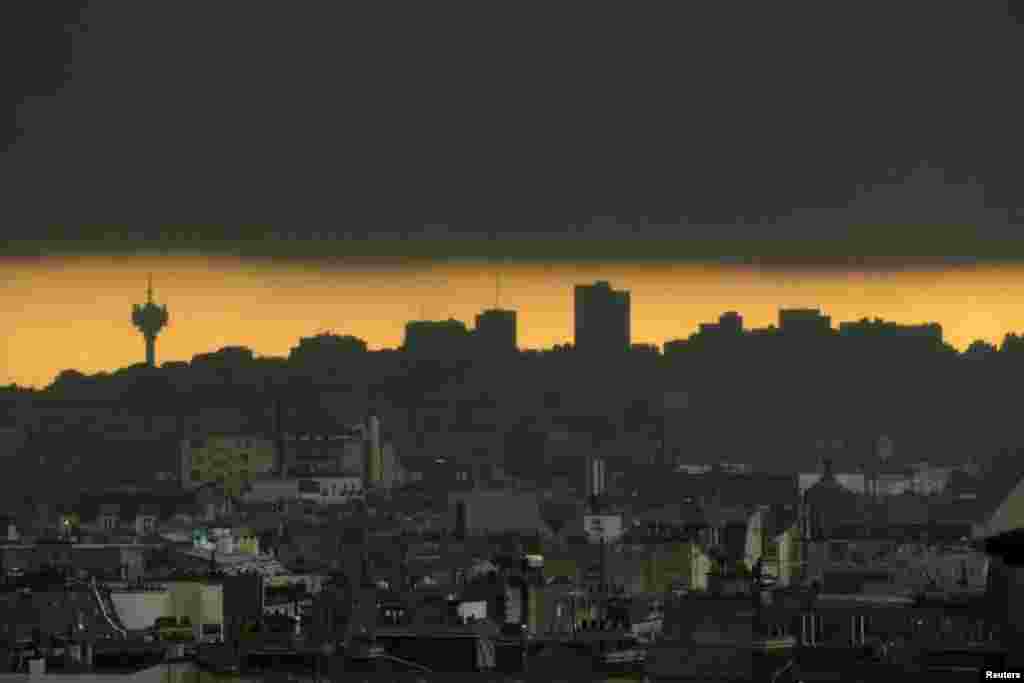 Dark clouds gather in the eastern Paris, France, skyline and city rooftops during a heavy rainstorm. 