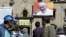 FILE - Pedestrians walk at San Francisco square where an image of Pope Francis is displayed in La Paz, Bolivia, June 30, 2015. 