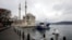 A worker sprays disinfectant outside Ortakoy Mosque to prevent the spread of coronavirus disease in Istanbul, Turkey, March 23, 2020. 
