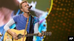 FILE - Chris Martin from the band Coldplay performs at MetLife Stadium in East Rutherford, New Jersey, July 16, 2016. 