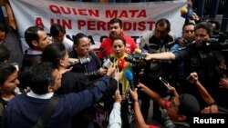 FILE - Frida Ortiz, wife of reporter Salvador Adame, speaks to the media during a protest against the May 18 disappearance of Adame, outside the offices of the Attorney General of the Republic in Mexico City, Mexico, June 1, 2017. 