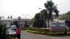 FILE - A man walk past signage for the National Hospital in Abuja, Nigeria, Jan. 14, 2016.