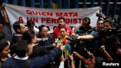 FILE - Frida Ortiz, wife of reporter Salvador Adame, speaks to the media during a protest against the May 18 disappearance of Adame, outside the offices of the Attorney General of the Republic in Mexico City, Mexico, June 1, 2017. 