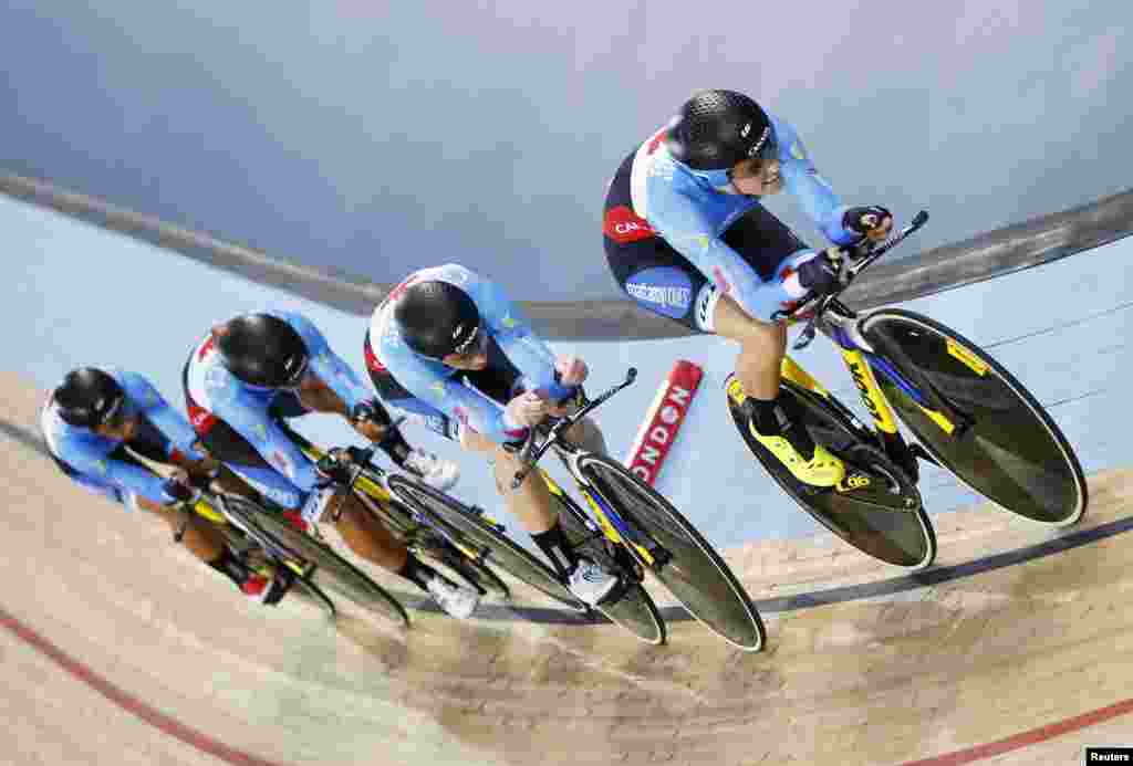 Canada&#39;s team competes in the first round of the women&#39;s team pursuit at the World Track Cycling championships at the Lee Valley Velopark in London.