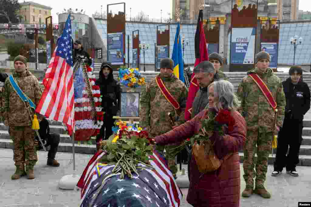 Leslie and John Hertweck pay their respects at the coffin of their son, U.S. Marine Corps veteran and volunteer combat medic in Ukraine Ethan Hertweck, during a memorial ceremony in Independence Square, in Kyiv, Ukraine.